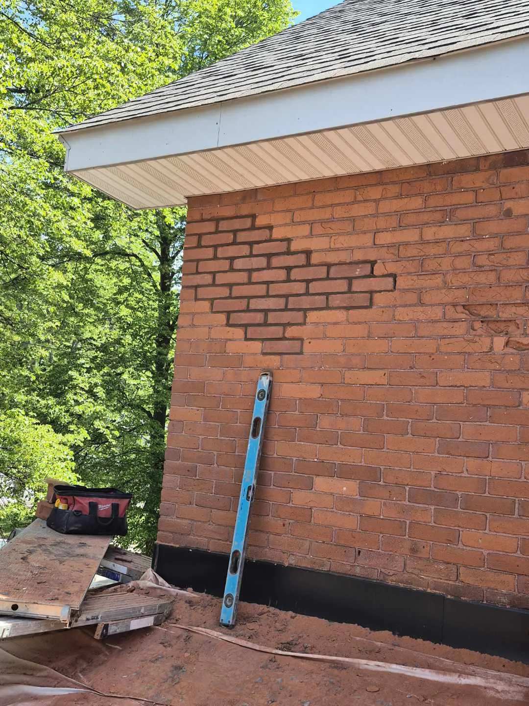 Replacement brick blended into an older red brick wall